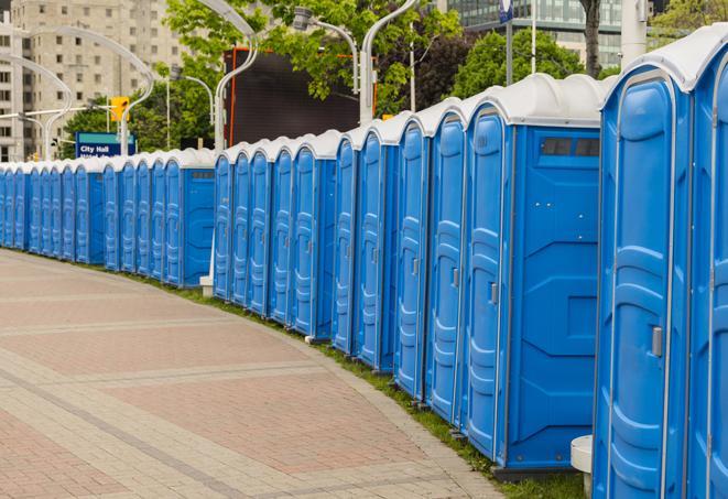 a line of portable restrooms at a sporting event, providing athletes and spectators with clean and accessible facilities in Amelia